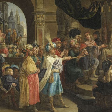 A group of elaborately dressed people in medieval clothing gathers around a throne in a grand hall. The scene is lively, evoking historical grandeur.