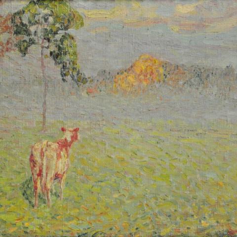 A cow stands in a misty field under a cloudy sky, gazing at a distant, sunlit hill. The scene conveys tranquility and the softness of dawn.